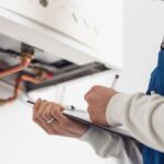 Professional Plumber Doing A Boiler Check 6MYA3MF 1 150x150
