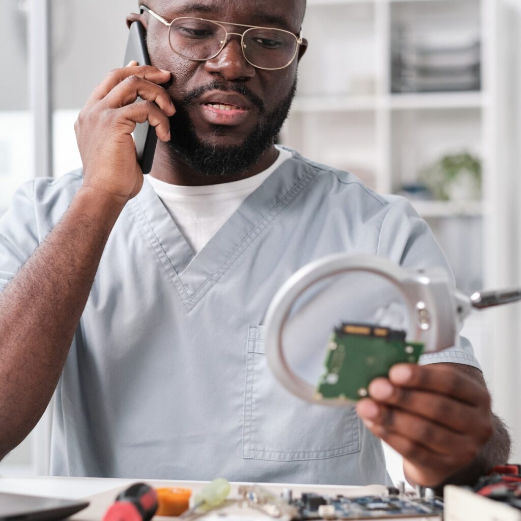 young confident technician in uniform consulting c slsv29k scaled.jpg